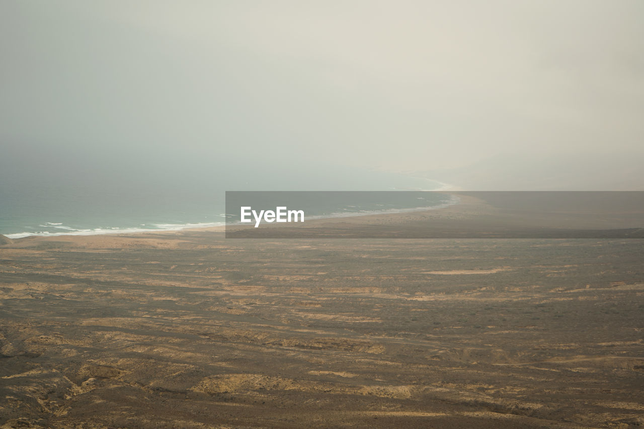 SCENIC VIEW OF SEA AND BEACH AGAINST SKY