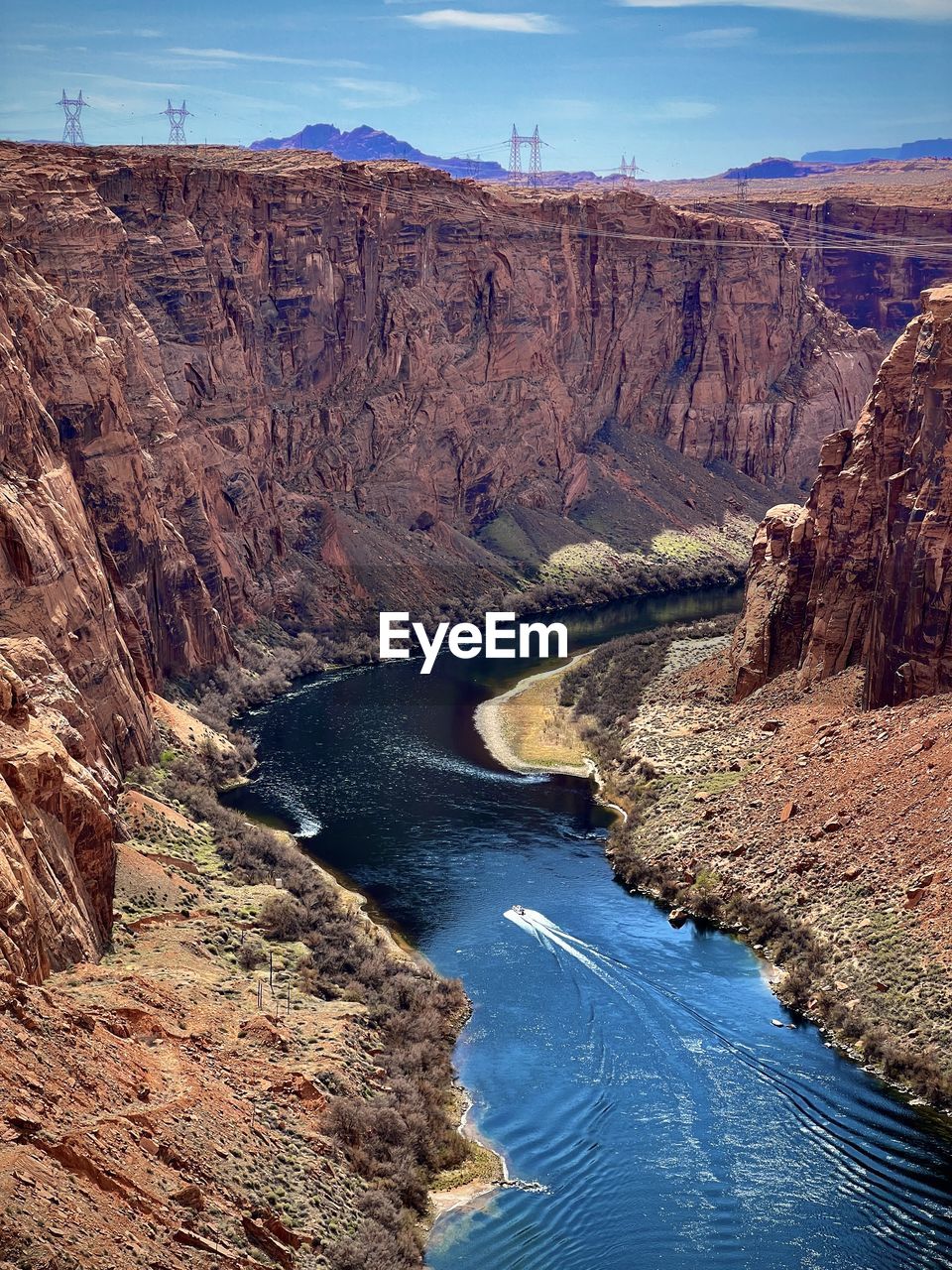 Boat traveling through the glen canyon dam and colorado river canyon in page, arizona.