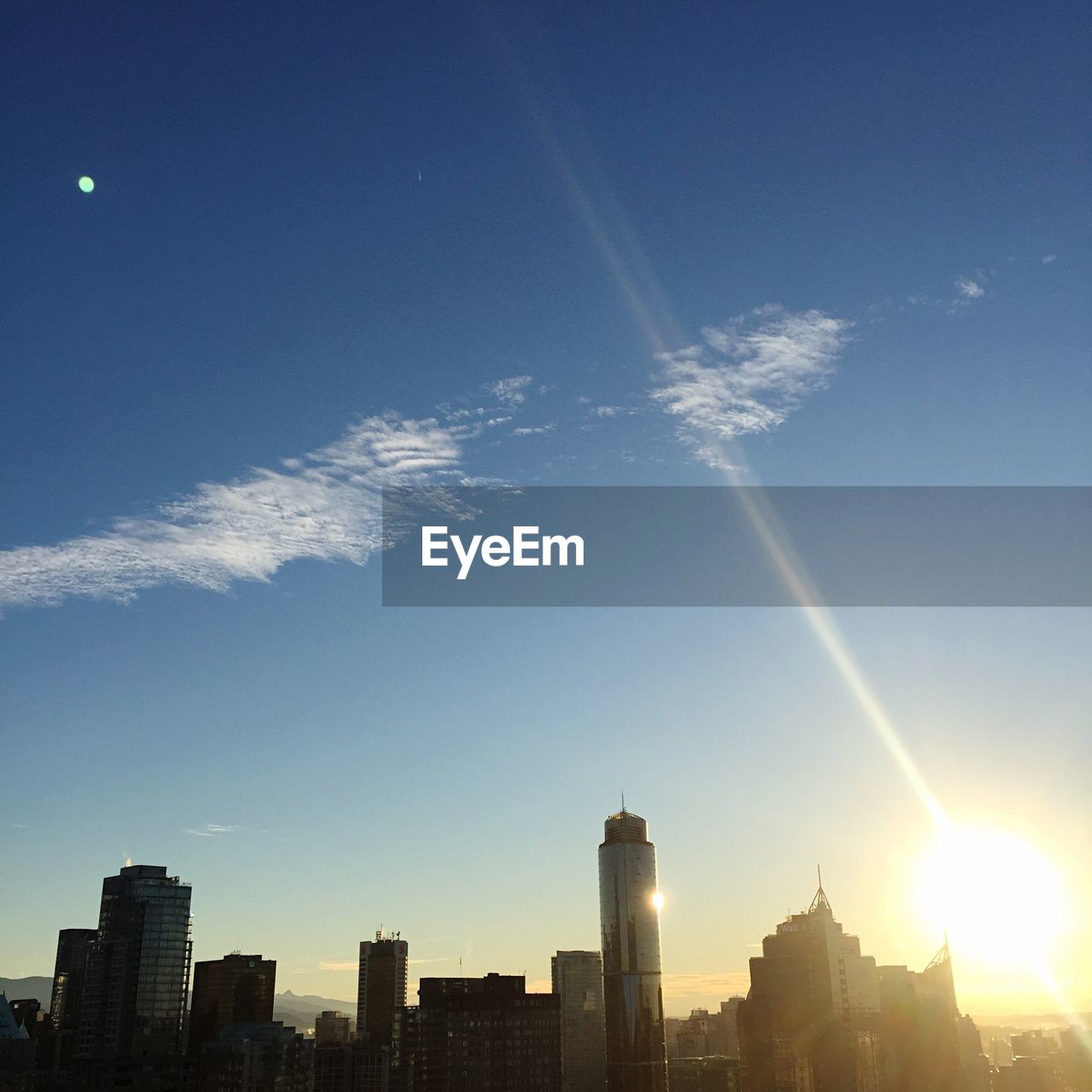 Sun shining over modern buildings