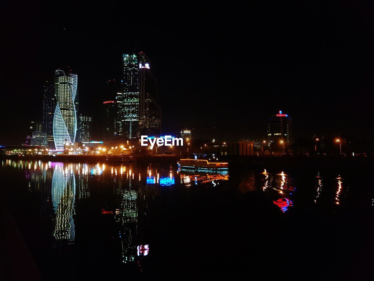 VIEW OF ILLUMINATED CITYSCAPE AT NIGHT