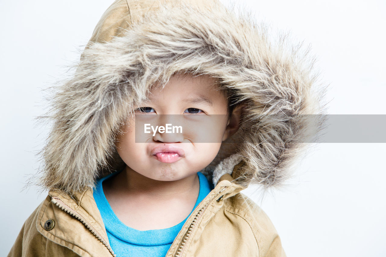 Portrait of cute boy wearing hooded jacket