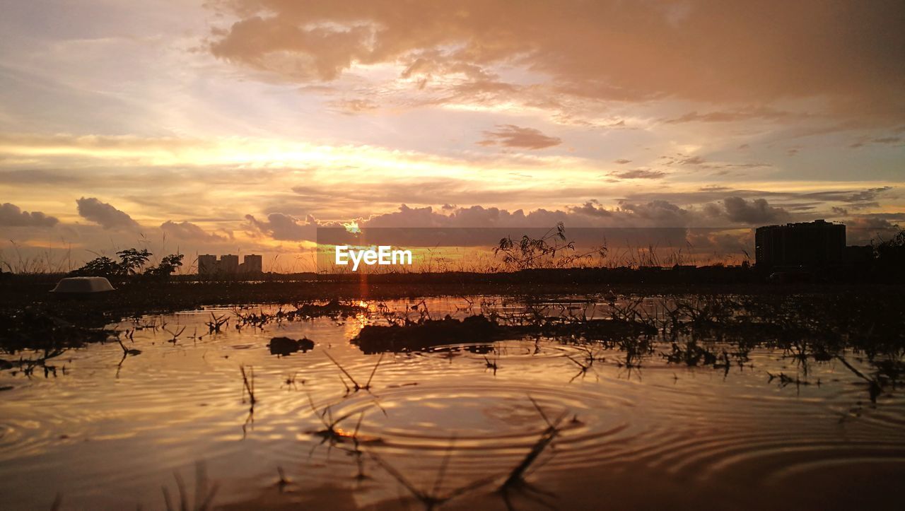 Scenic view of lake against sky during sunset