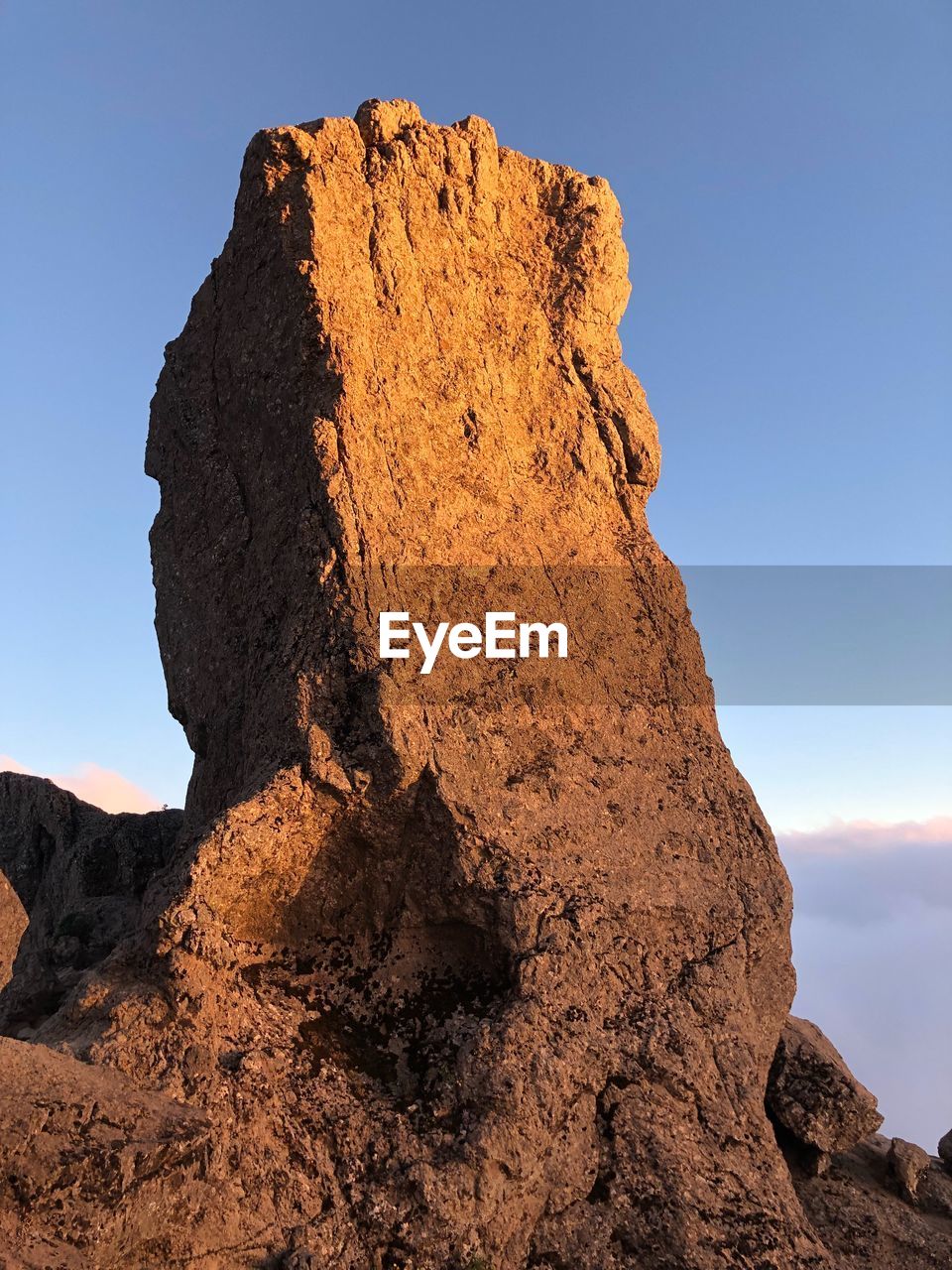 Low angle view of rock formation on land against sky