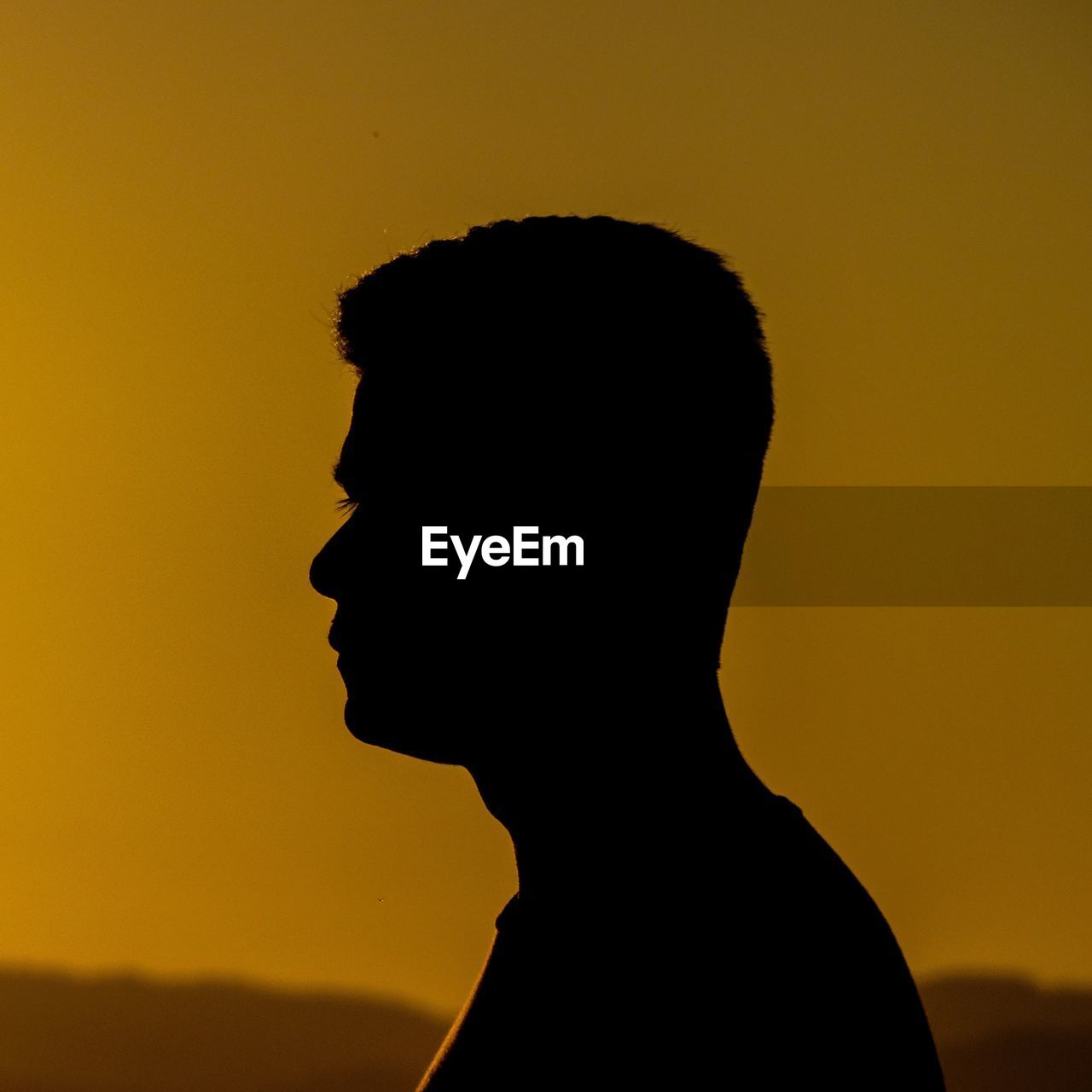 Side view of silhouette man against sky during sunset