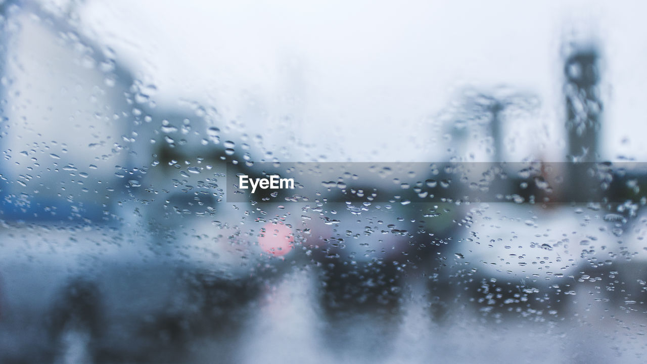 Full frame shot of wet glass window in rainy season