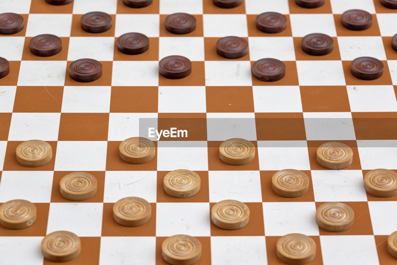 High angle view of game pieces on chess board