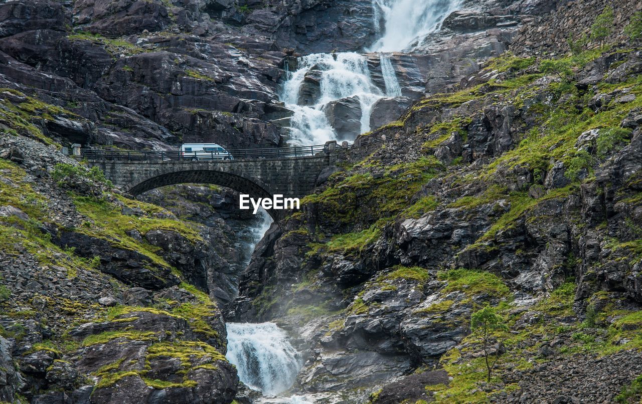 Scenic view of waterfall against sky