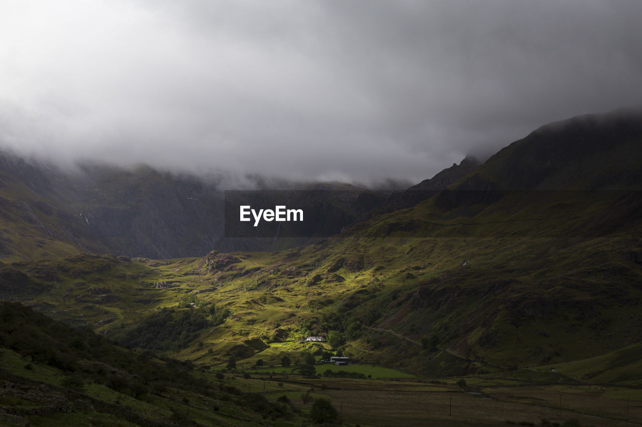 SCENIC VIEW OF LANDSCAPE AND MOUNTAINS AGAINST SKY