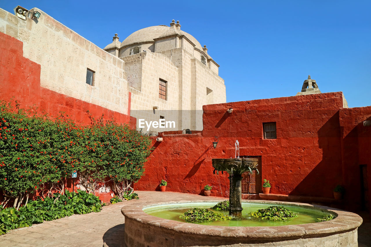 Courtyard of the convent of santa catalina de siena with a vintage stone fountain, arequipa, peru