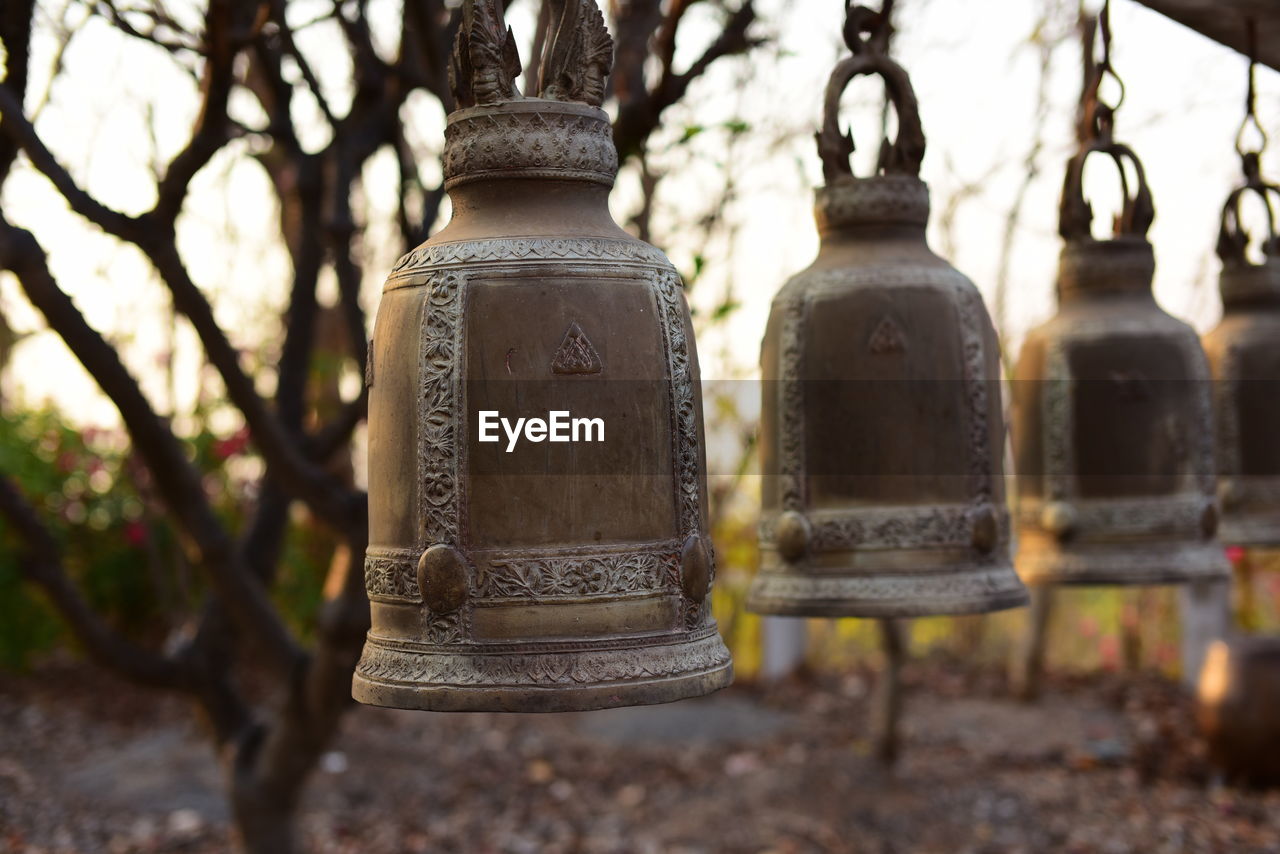 CLOSE-UP OF OLD LANTERNS HANGING IN TEMPLE