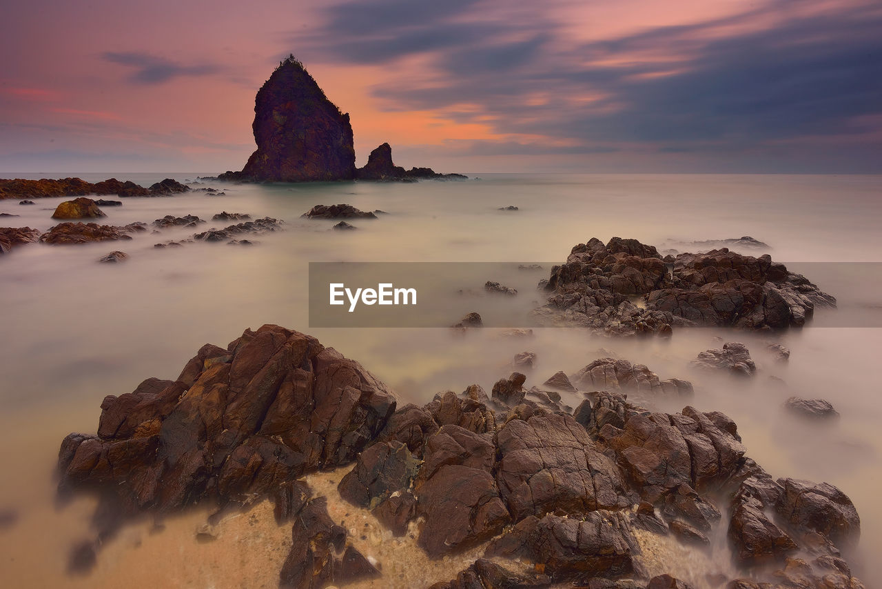 Scenic view of foggy sea against cloudy sky