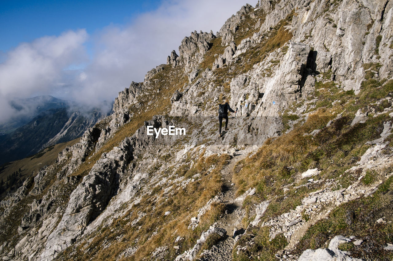 Full length of woman walking on mountain ridge