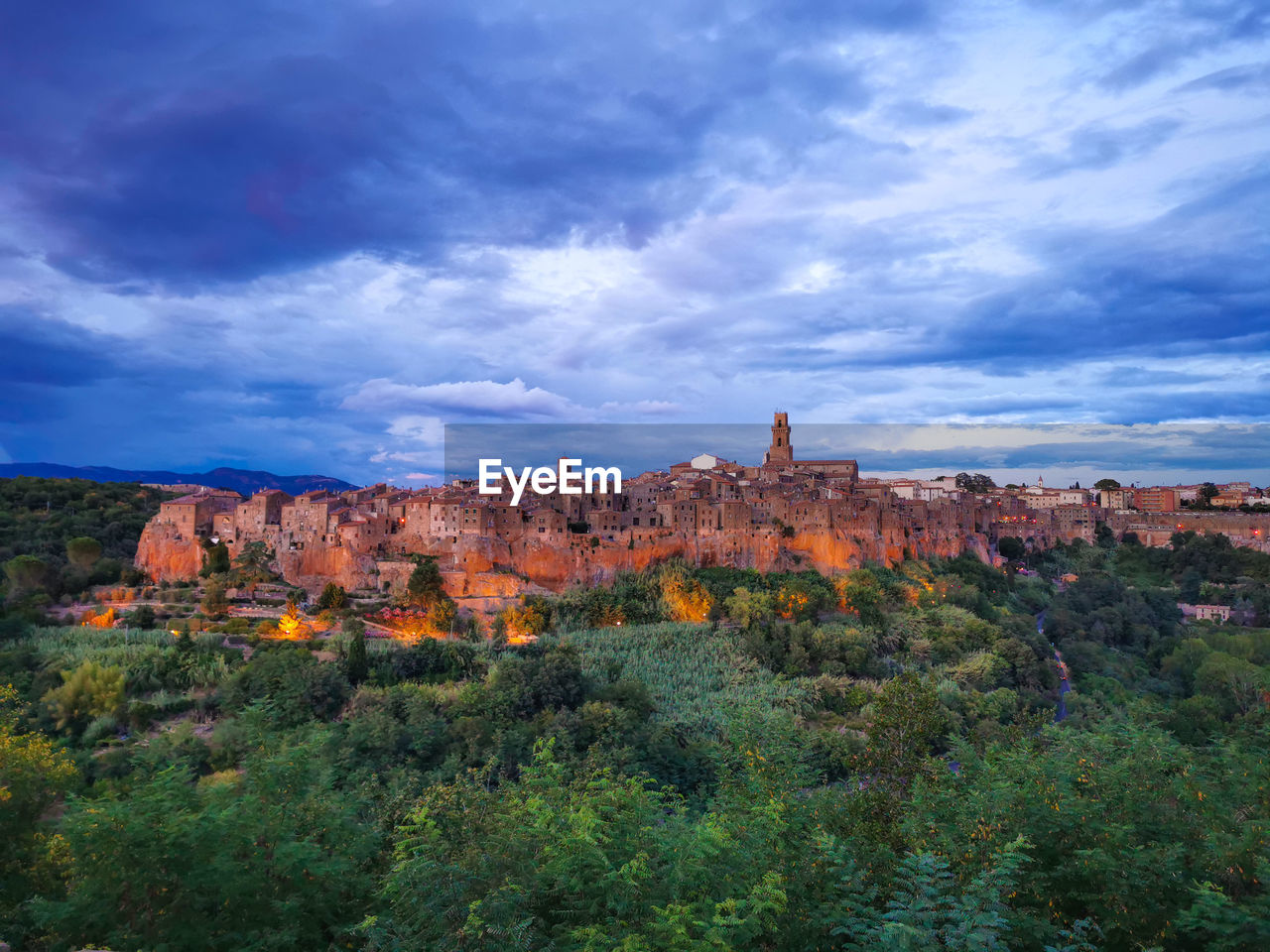 View of landscape against cloudy sky of city of pitigliano in italy 