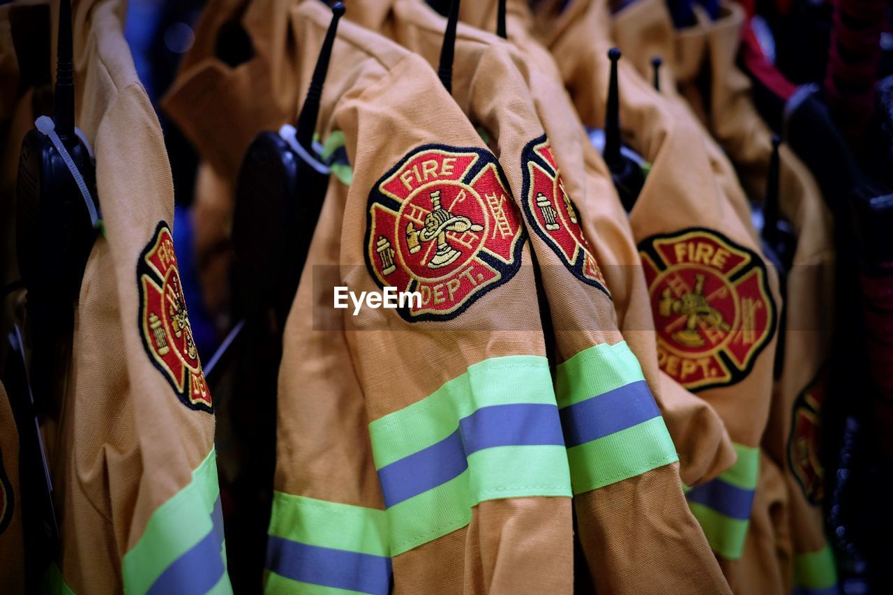 Close-up of uniforms hanging in store for sale