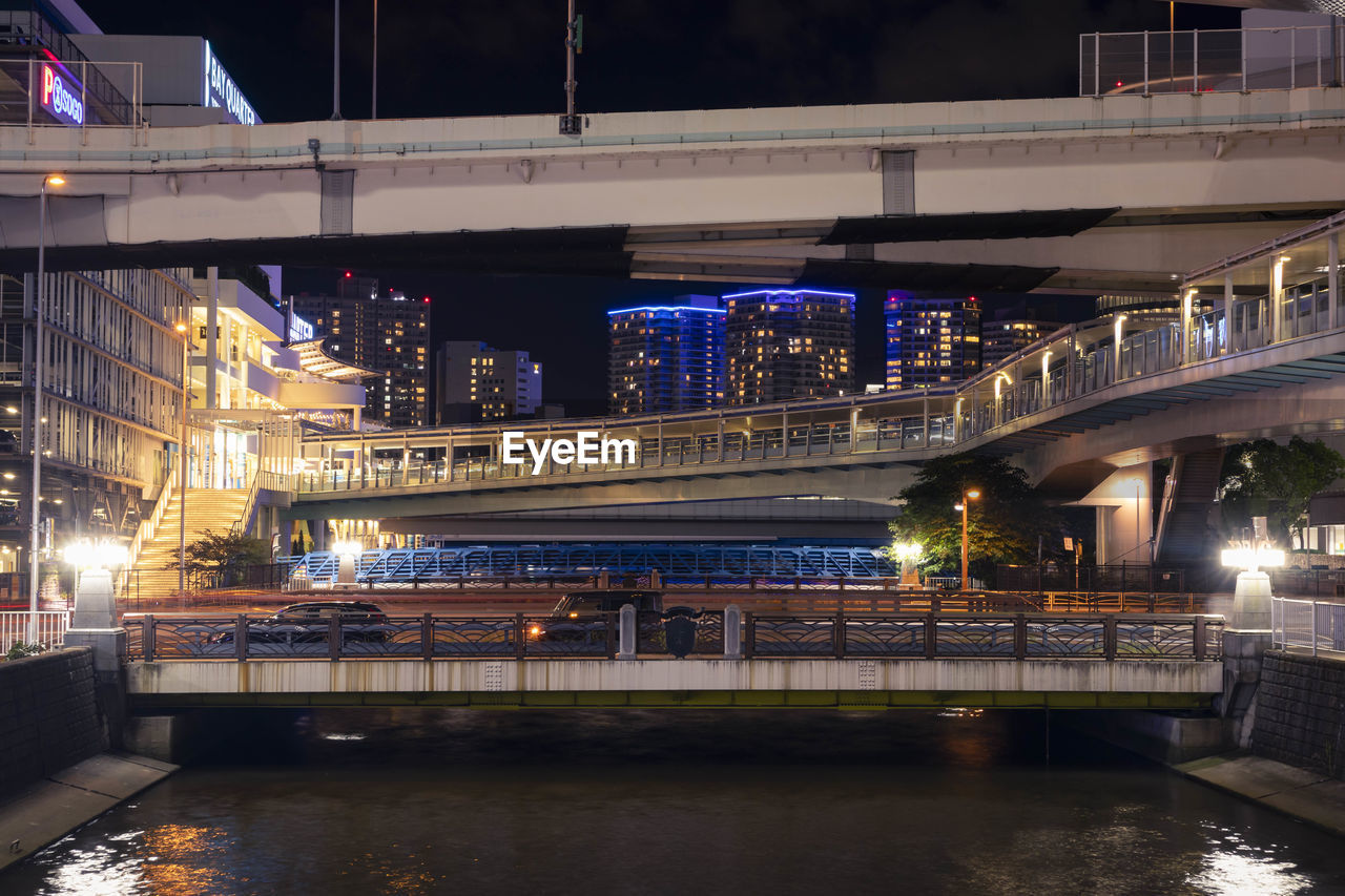 Elevated highway above the pedastrian bridge and cannel in yokohama, japan at night.