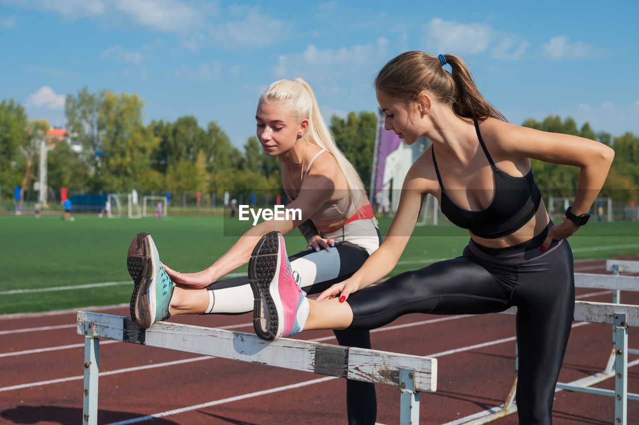 portrait of young woman exercising on exercise mat