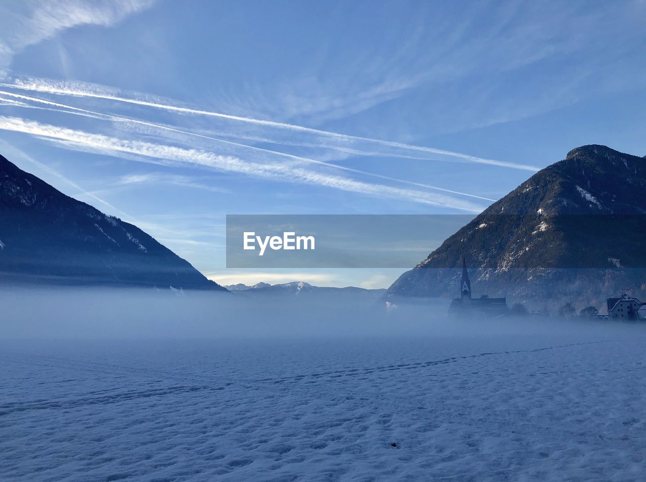 Scenic view of snowcapped mountains against sky