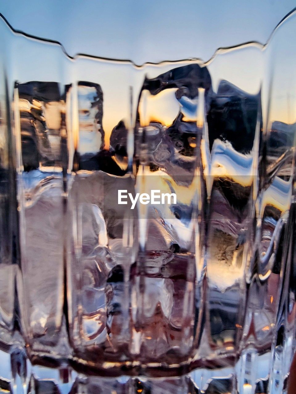 Colorful empty glass with ice cubes