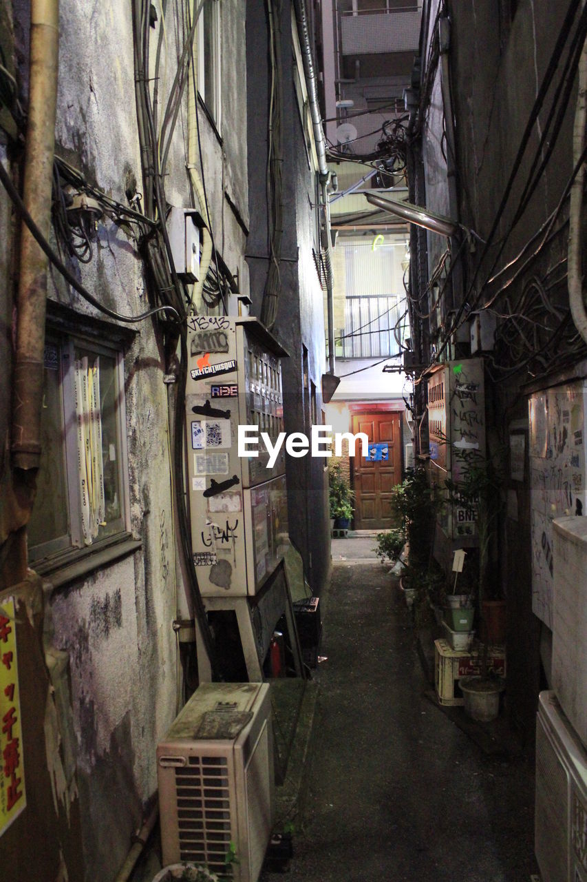 Alley amidst buildings at night