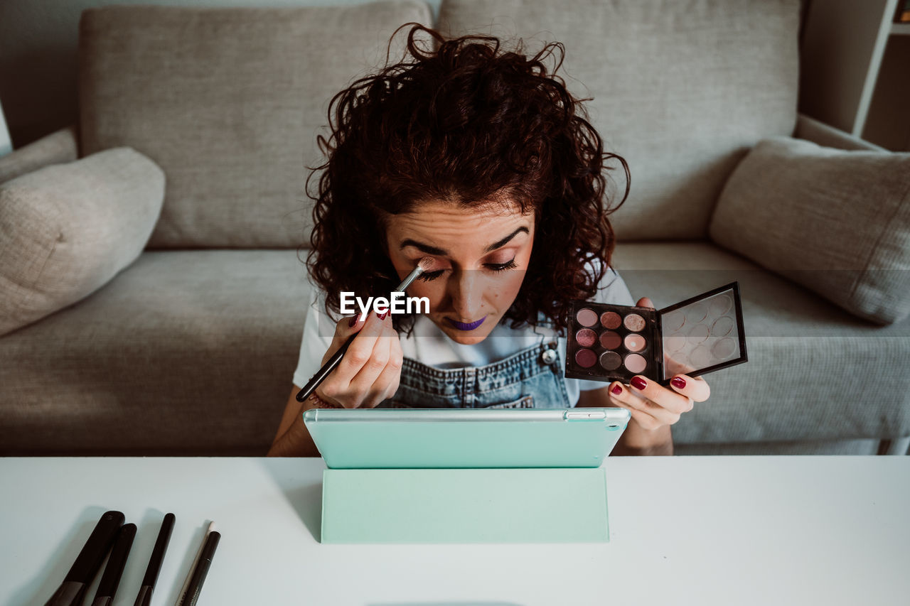 Woman applying eyeshadow