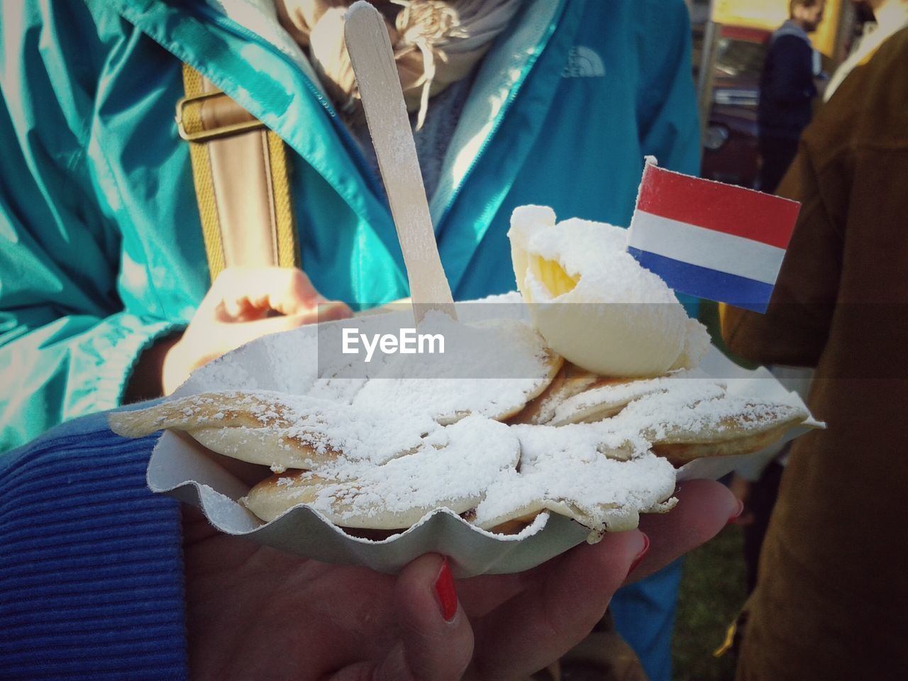 Friends holding poffertjes with dutch flag