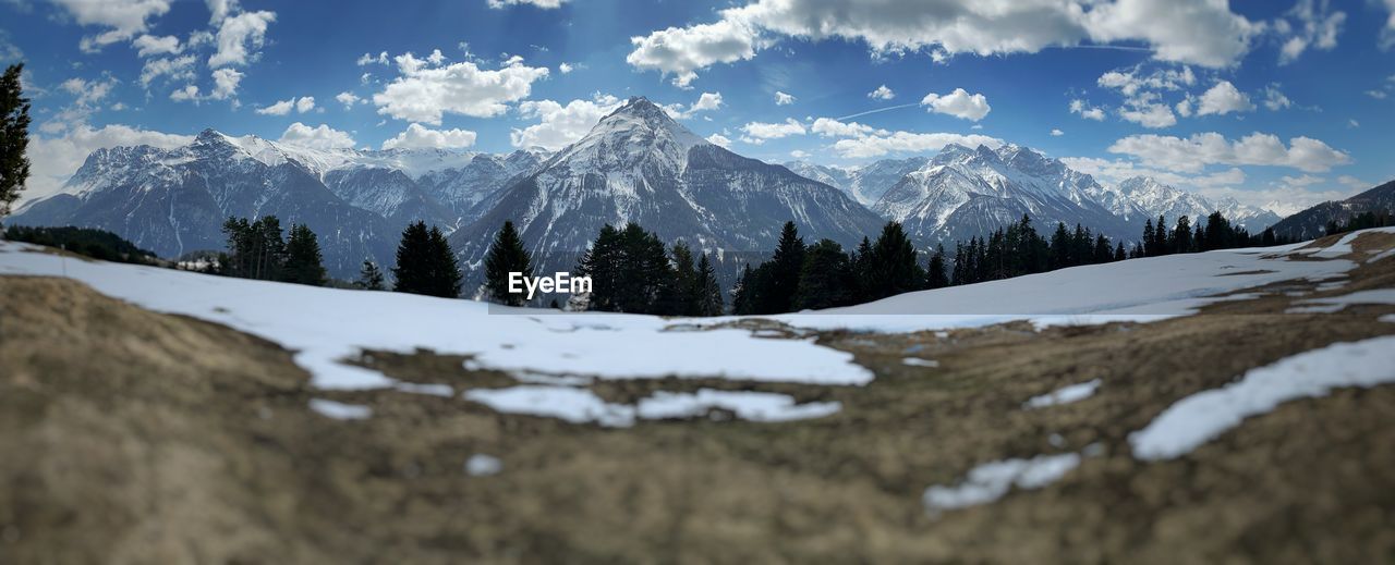 PANORAMIC SHOT OF SNOWCAPPED LANDSCAPE AGAINST SKY