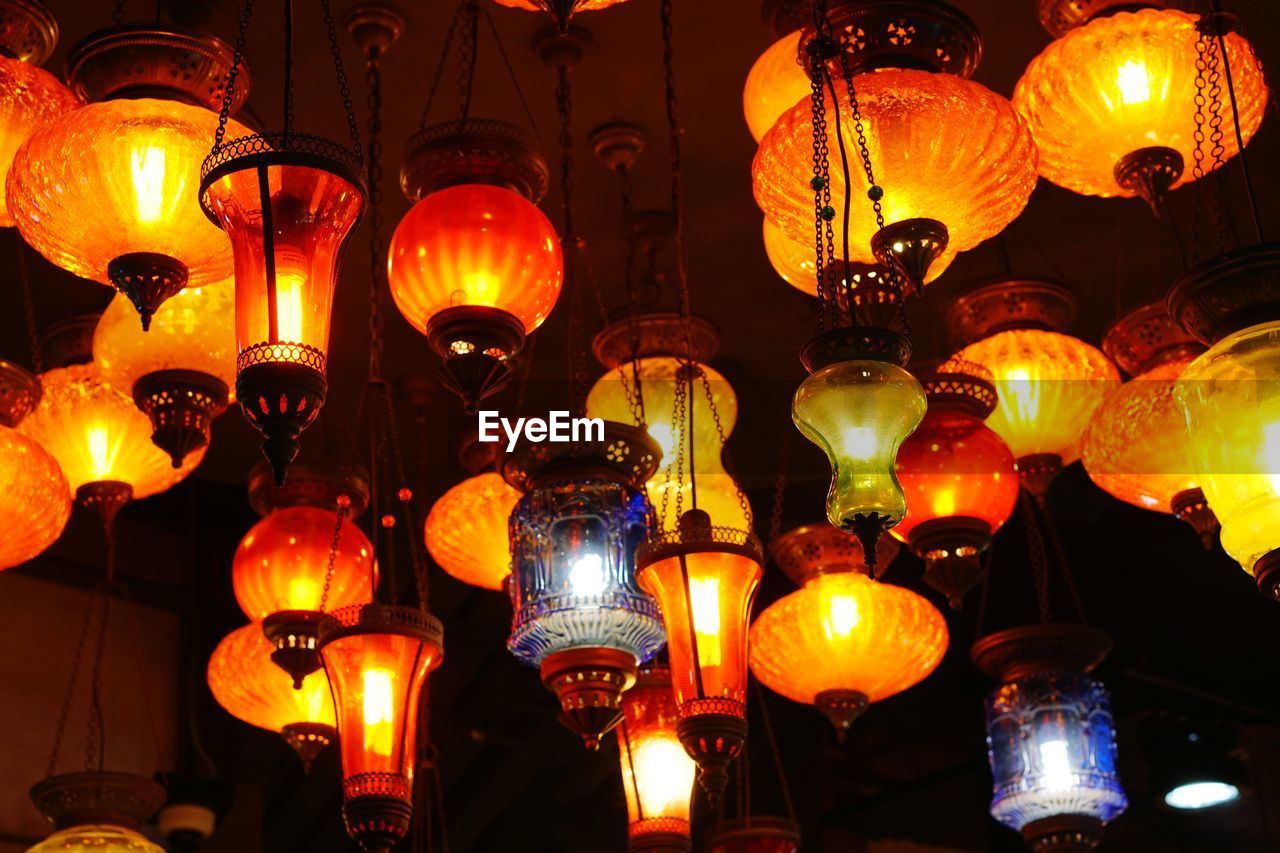 Illuminated lanterns hanging at market stall
