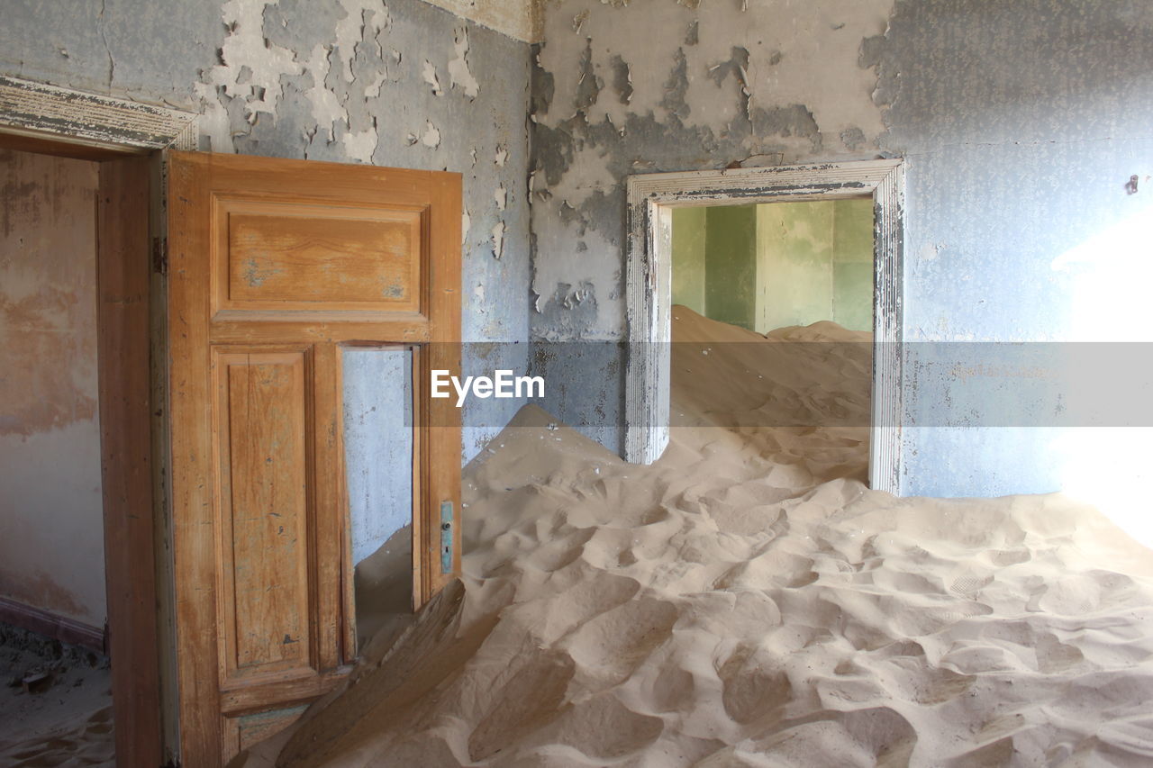 The sand in an abandoned house in the village of kolmanskop, namibia. 