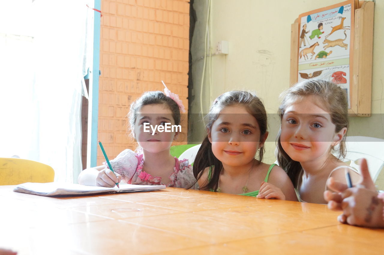 Portrait of cute smiling girls at home