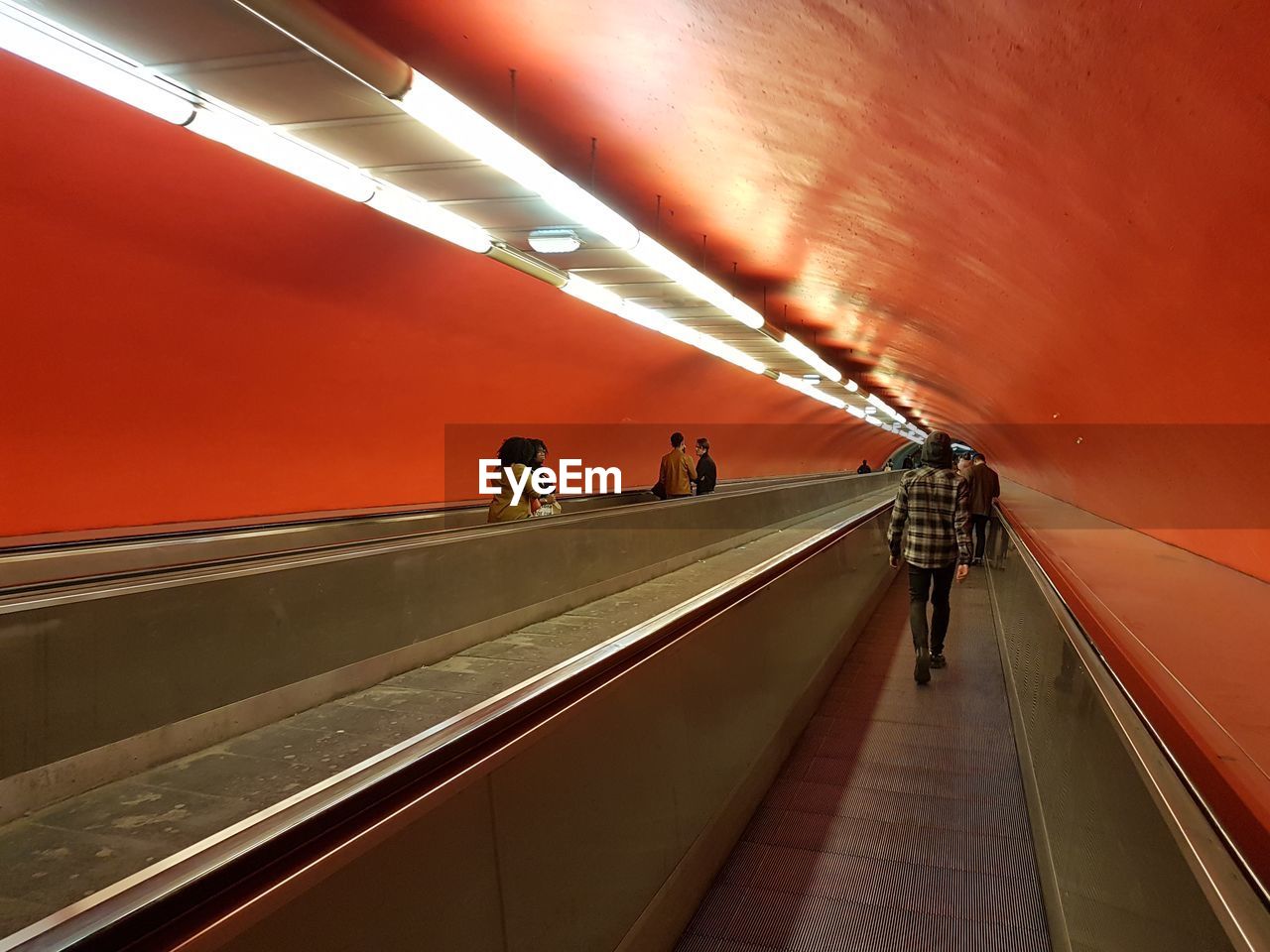 People walking on escalator in subway