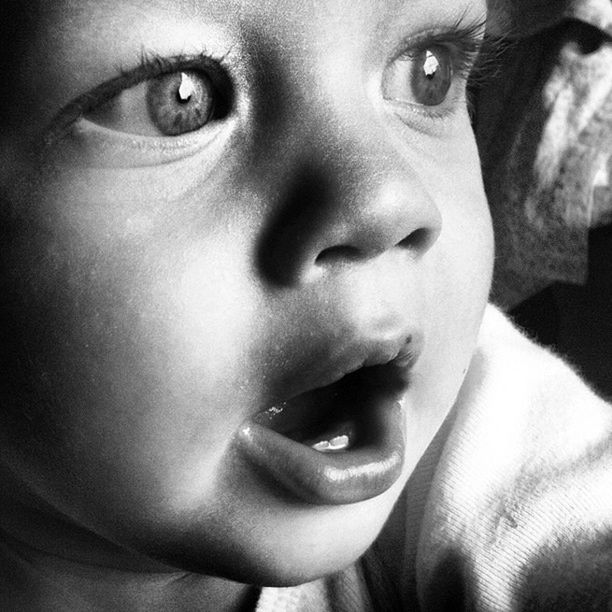 Close-up of cute boy yawning at home