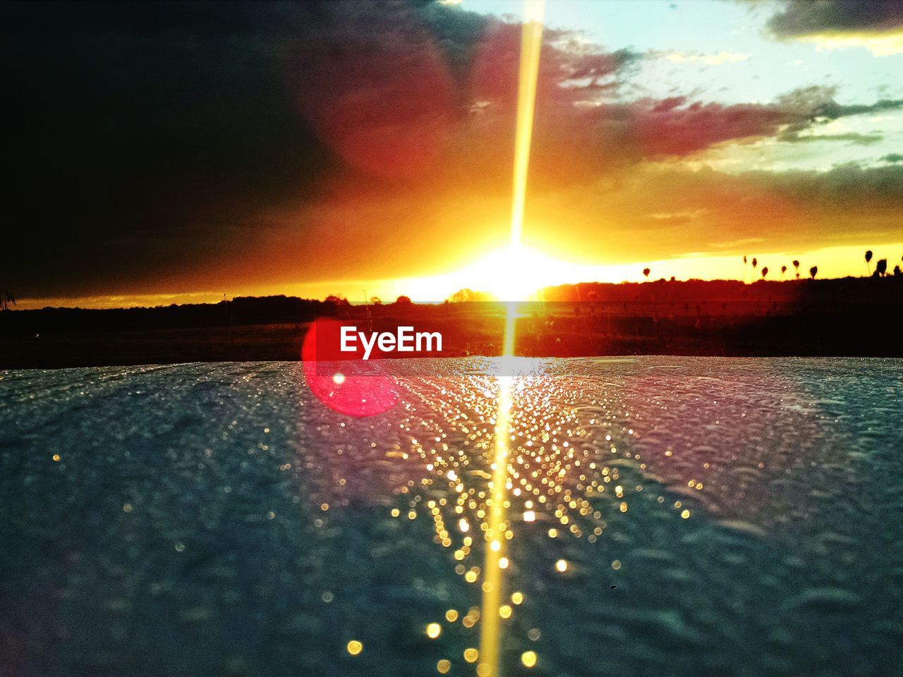 Scenic view of field against sky during sunset