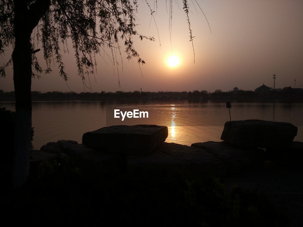 SCENIC VIEW OF LAKE AT SUNSET