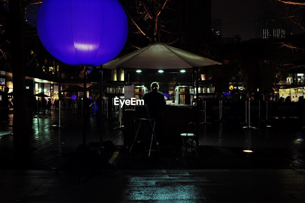 PEOPLE STANDING AT NIGHT