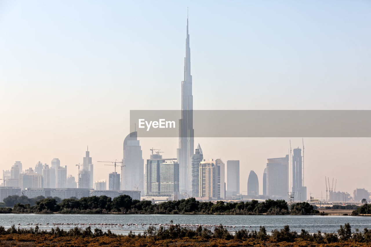 View of buildings in city against clear sky