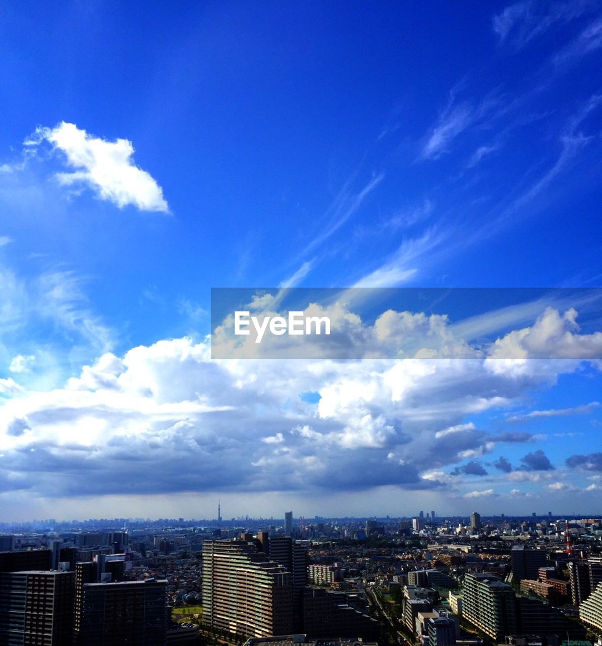 MODERN CITYSCAPE AGAINST BLUE SKY