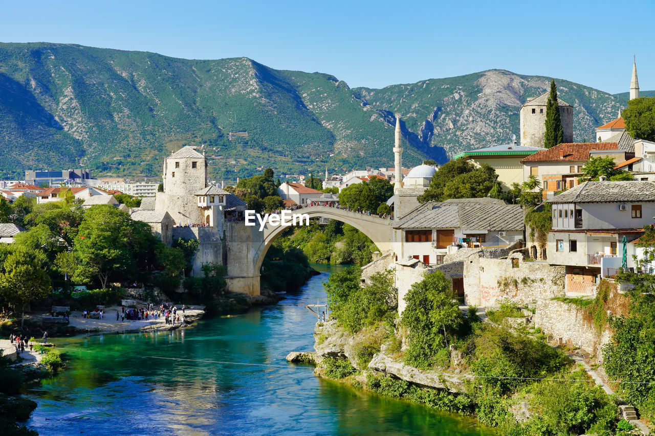 Bridge over river amidst buildings