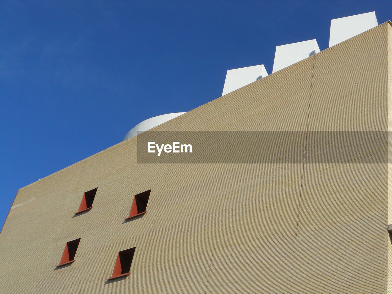 Low angle view of building against clear blue sky. minimal