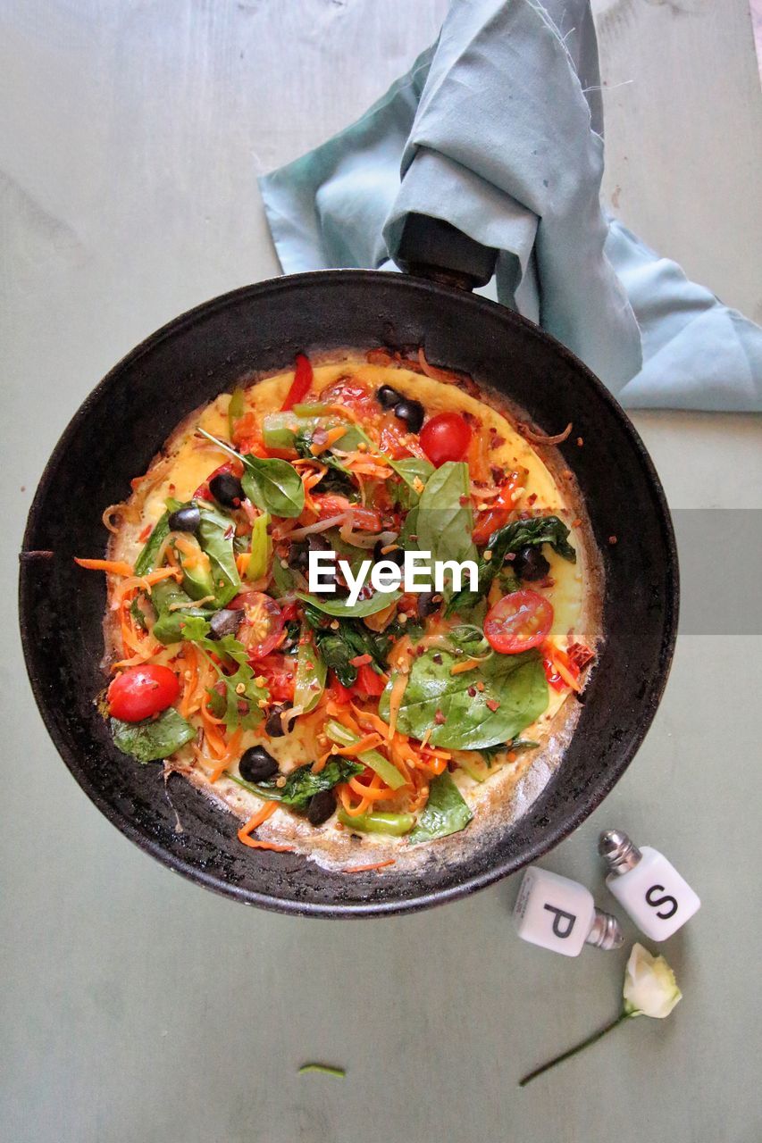 Directly above shot of omelet in frying pan on table