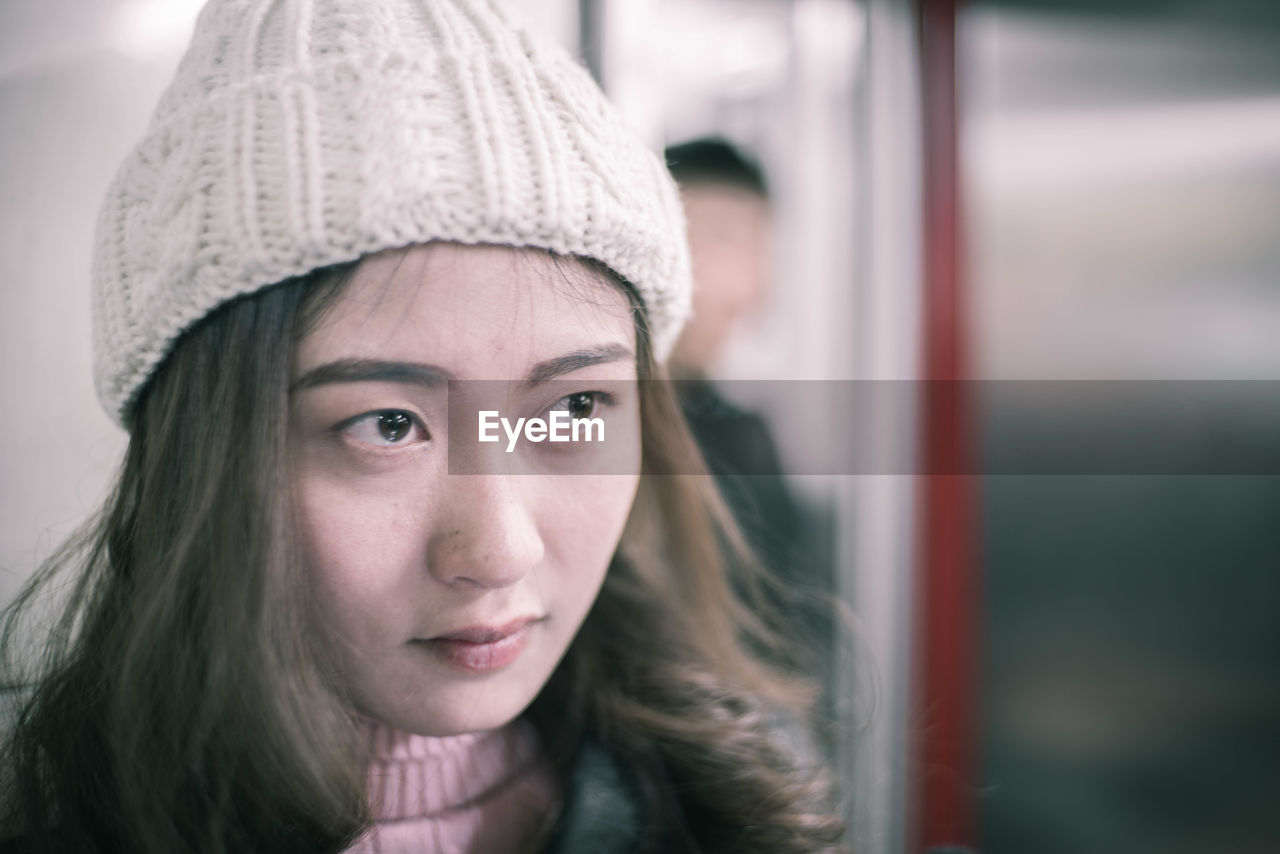 Close-up of thoughtful young woman in train