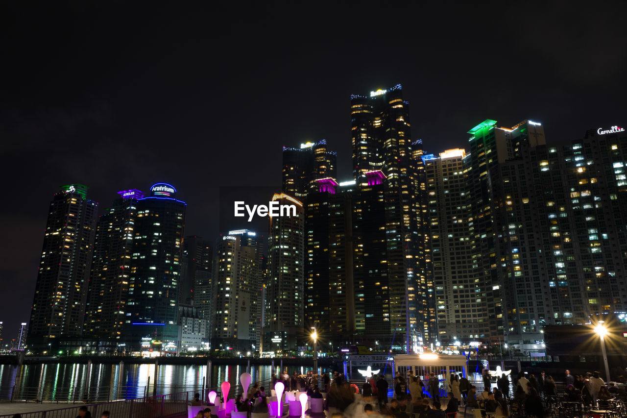 ILLUMINATED CITY BUILDINGS AT NIGHT