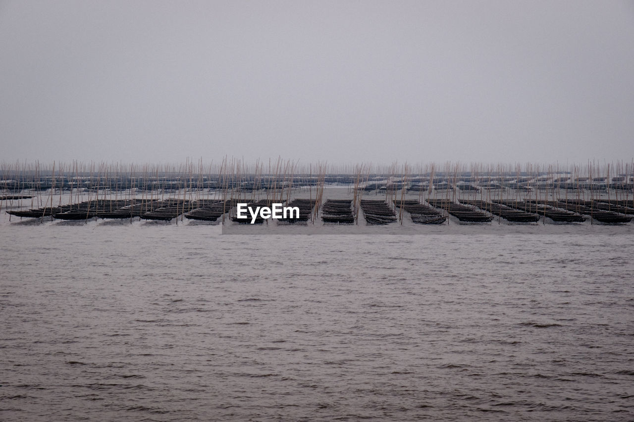 water, sea, wave, horizon, shore, sky, ocean, nature, coast, no people, breakwater, pier, scenics - nature, architecture, day, beauty in nature, built structure, tranquility, tranquil scene, outdoors, waterfront, copy space, environment, bay, transportation, dock, vehicle, non-urban scene, land