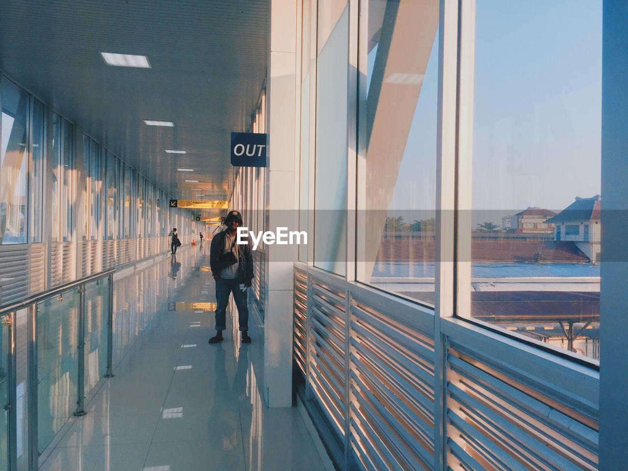 Man standing in corridor of building