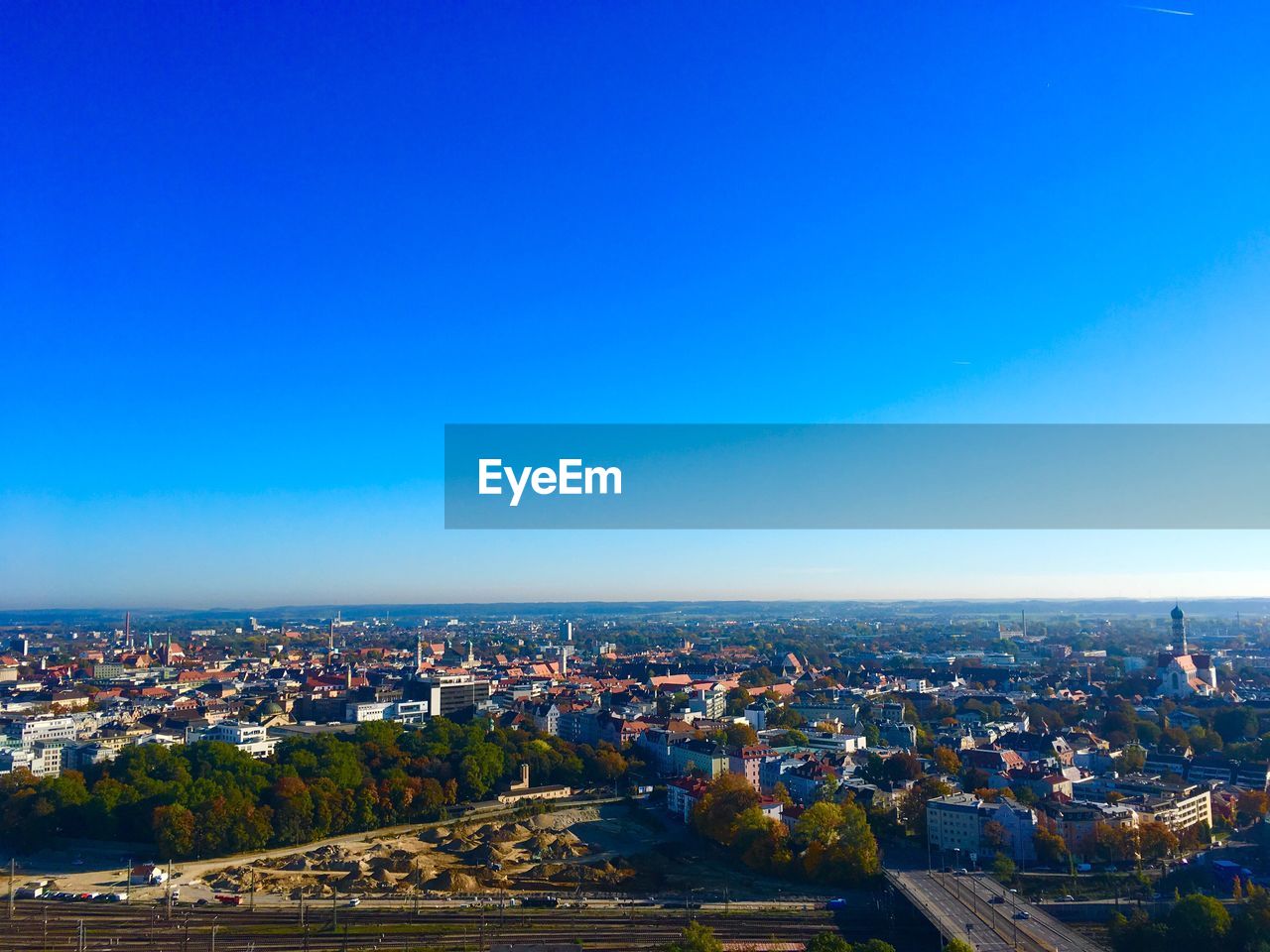 High angle shot of townscape against blue sky