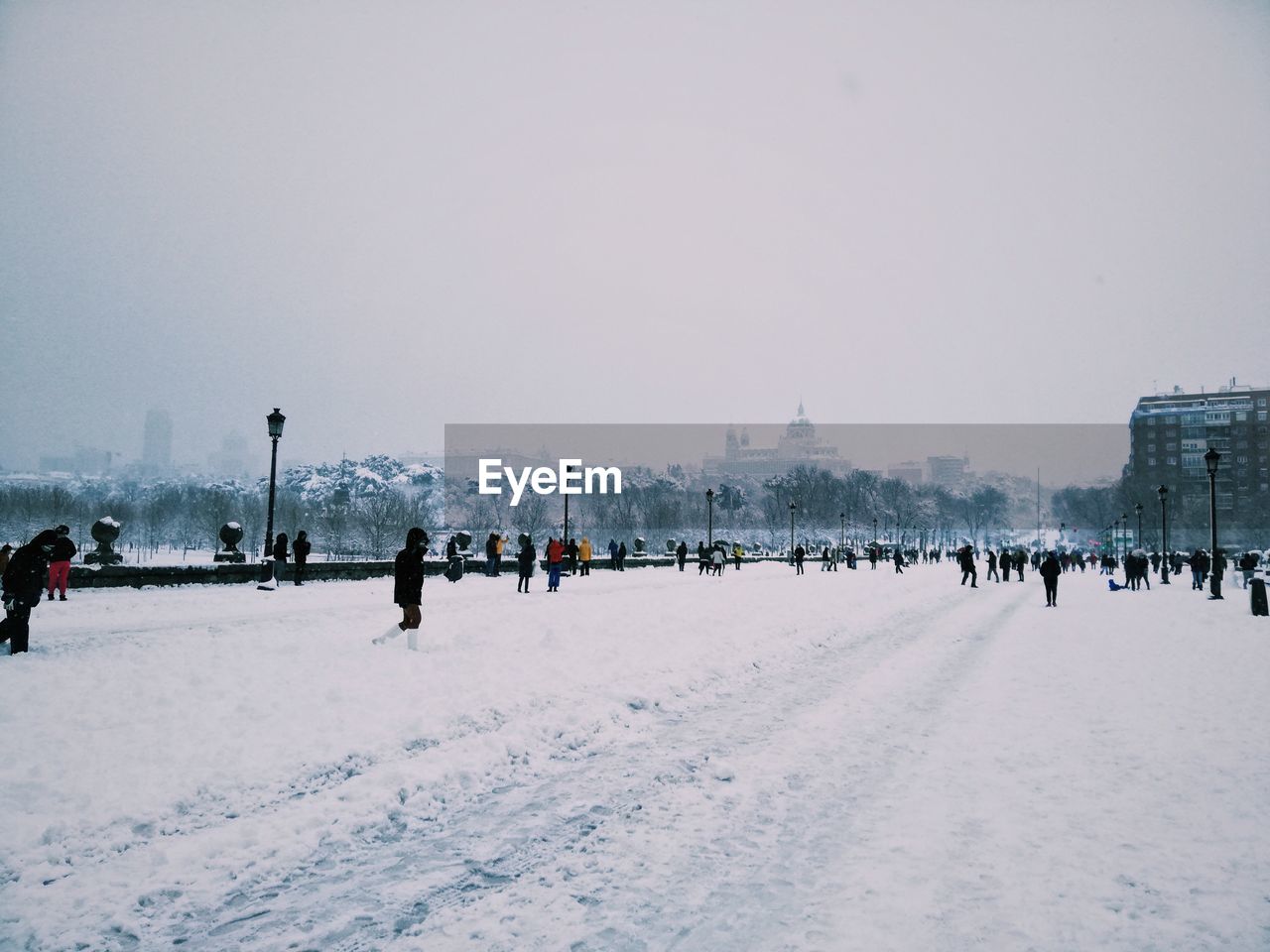 PEOPLE WALKING IN SNOW COVERED CITY