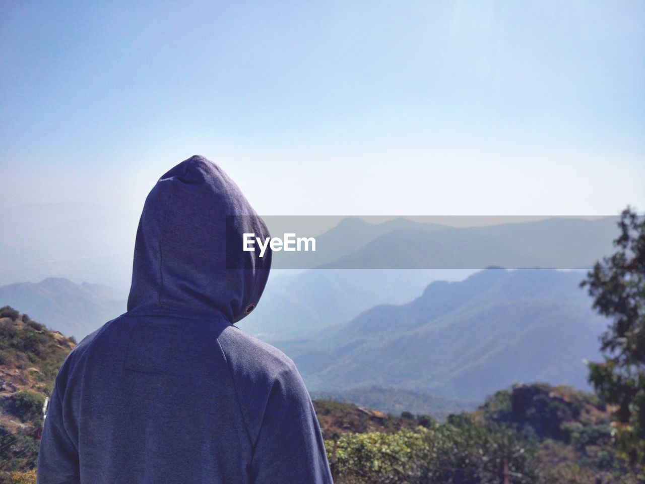 Rear view of man on mountain against sky