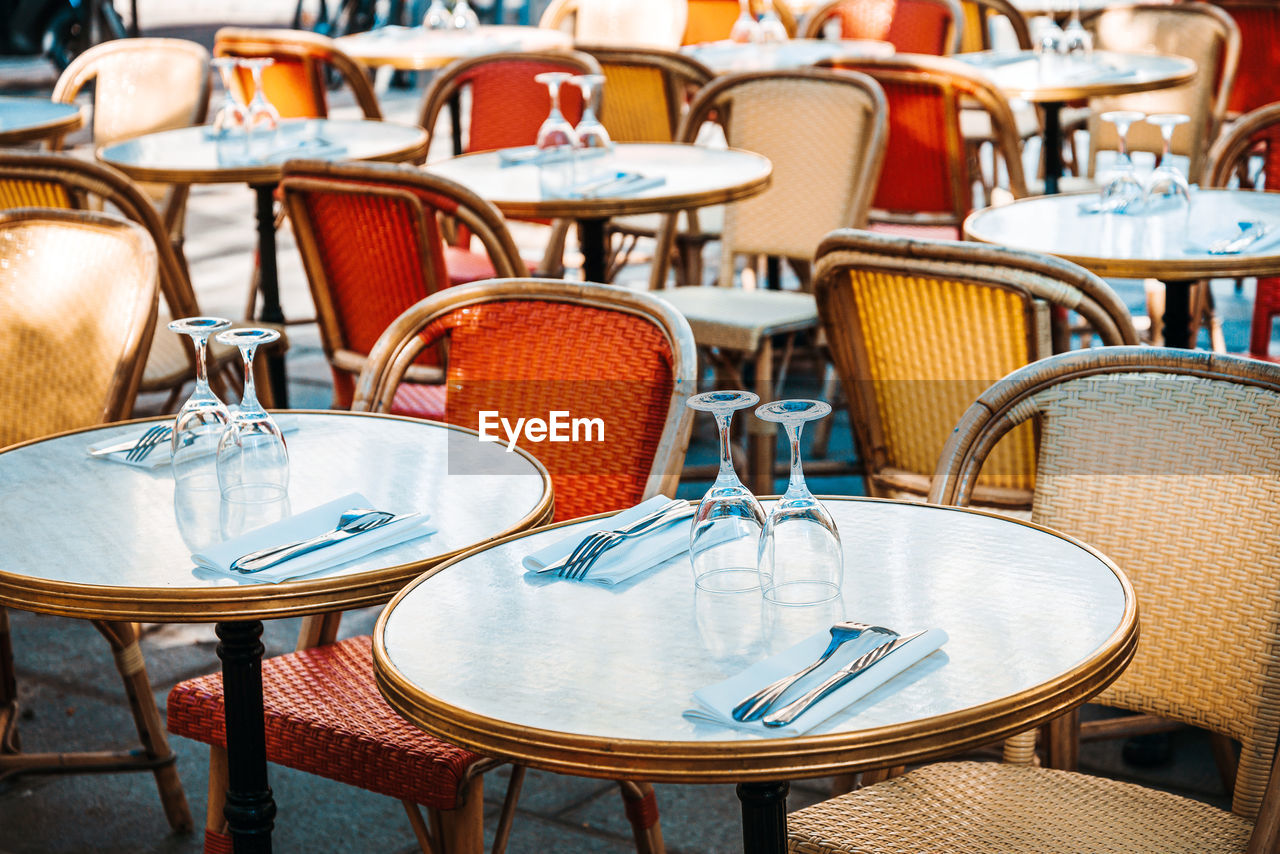 EMPTY CHAIRS AND TABLES AT RESTAURANT