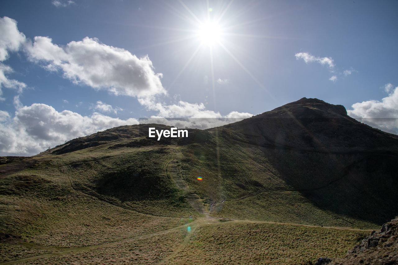 SCENIC VIEW OF SUN SHINING OVER LANDSCAPE