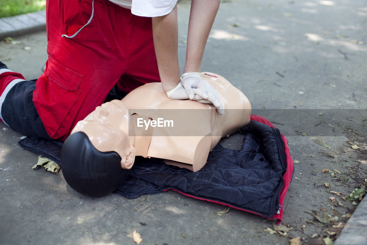 Low section of woman applying cpr on dummy