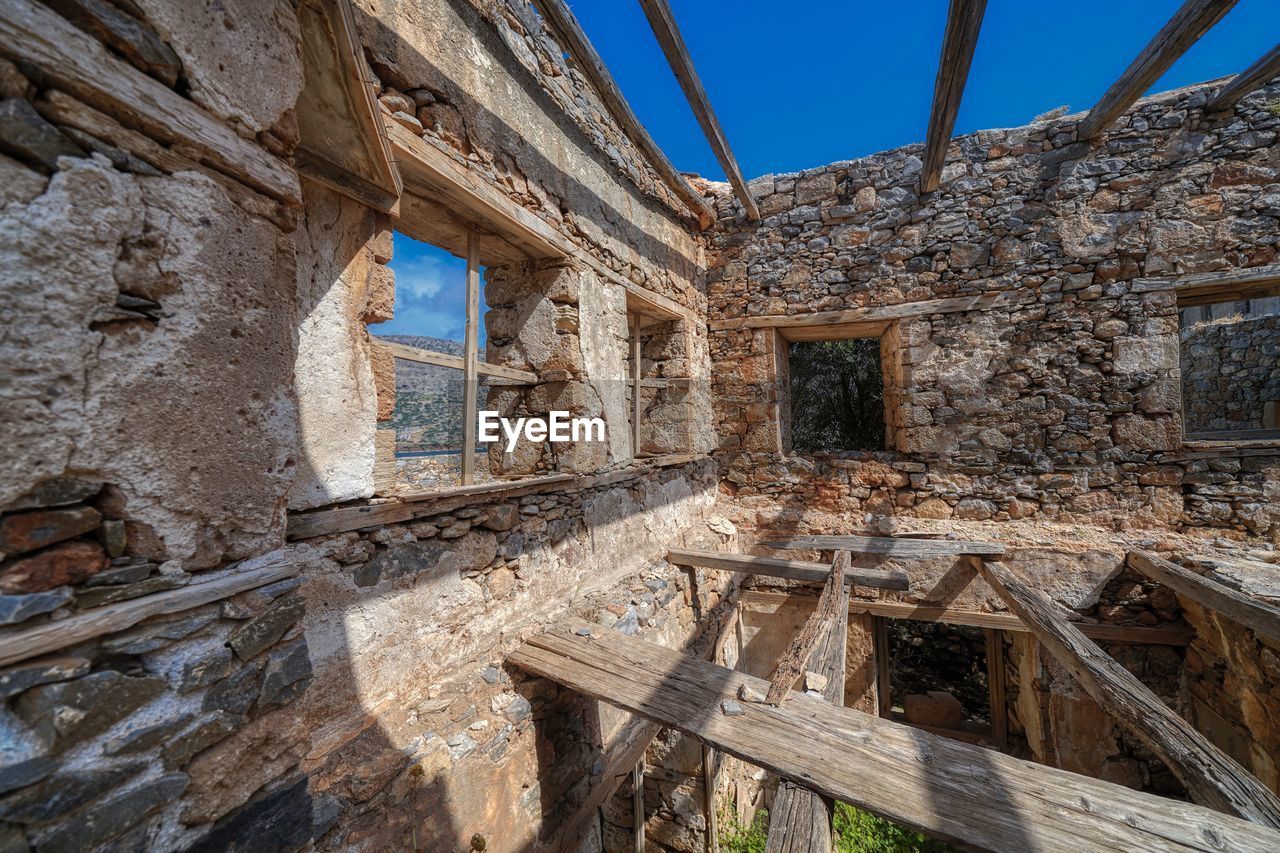 Damaged building against sky